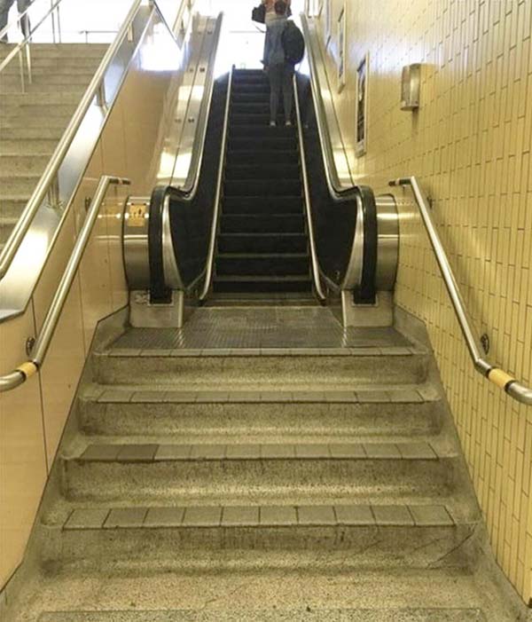 an escalator which is not accessible unless you climb up 4 stairs